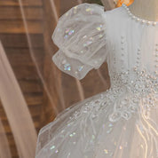 White girls party dress puff sleeve and embroidered bodice detail, close-up