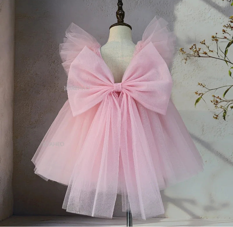 Pink tulle party dress back view with oversized bow
