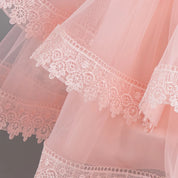 Layered lace-trim skirt detail on pink party dress