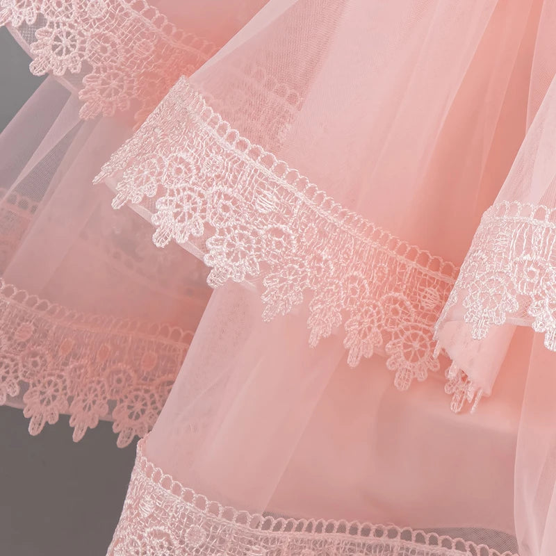 Layered lace-trim skirt detail on pink party dress