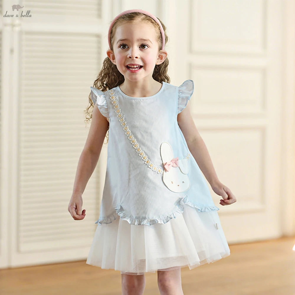 Girl wearing a pale blue bunny dress with layered white skirt, front view