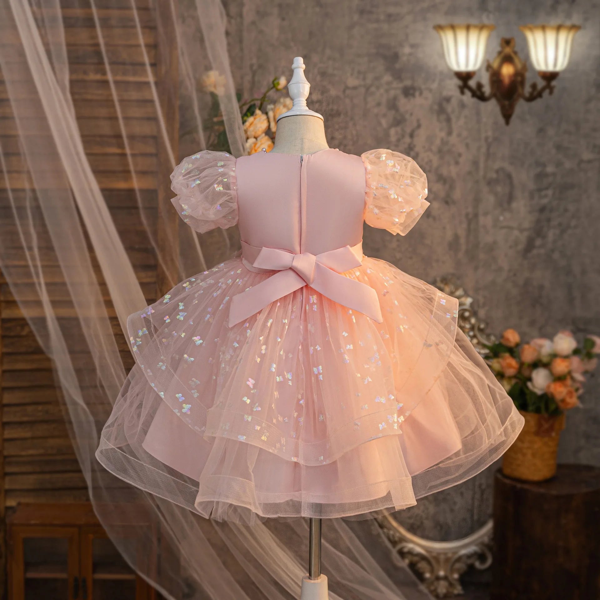 Pink girls party dress with back bow and puff sleeves, rear view