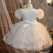 White girls party dress with back bow and layered skirt, rear view