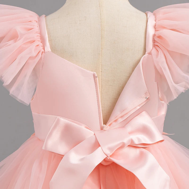 Back zipper and bow detail on pink girls party dress