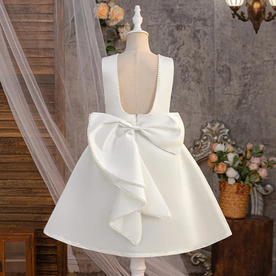 White pearl bow flower girl dress back view with oversized bow