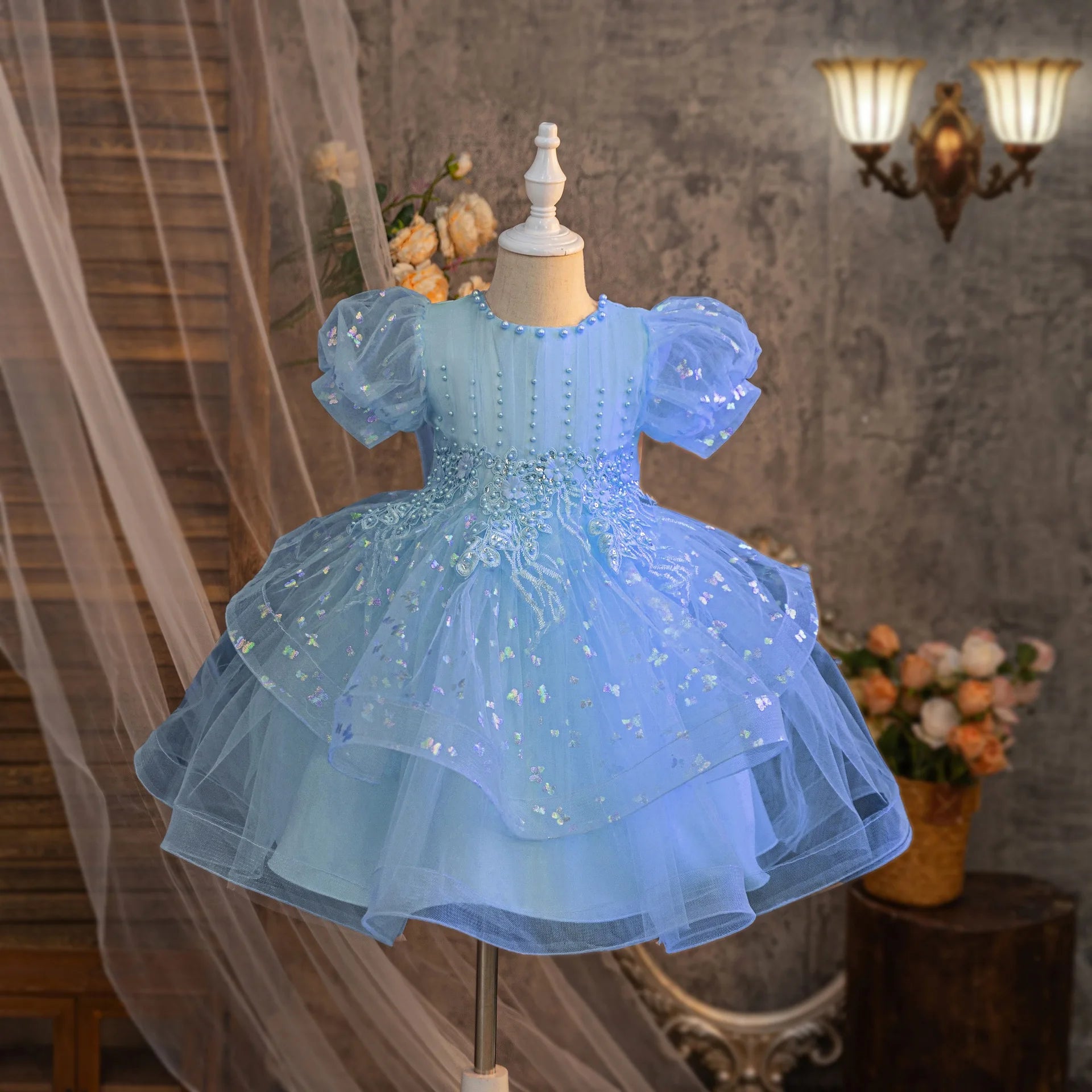 Blue girls party dress with puff sleeves, embroidered bodice and layered skirt, front view