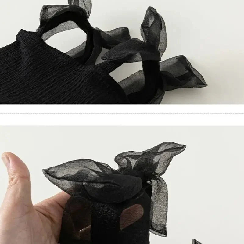 Babelio black toddler summer dress with sheer bow straps, close-up detail on fabric