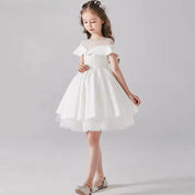 Babelio flower girl in white formal dress with floral headband, studio background