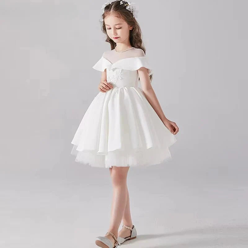 Babelio flower girl in white formal dress with floral headband, studio background