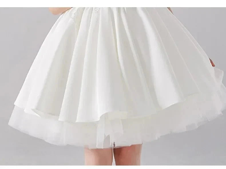 Babelio white flower girl dress with layered skirt in formal studio setting