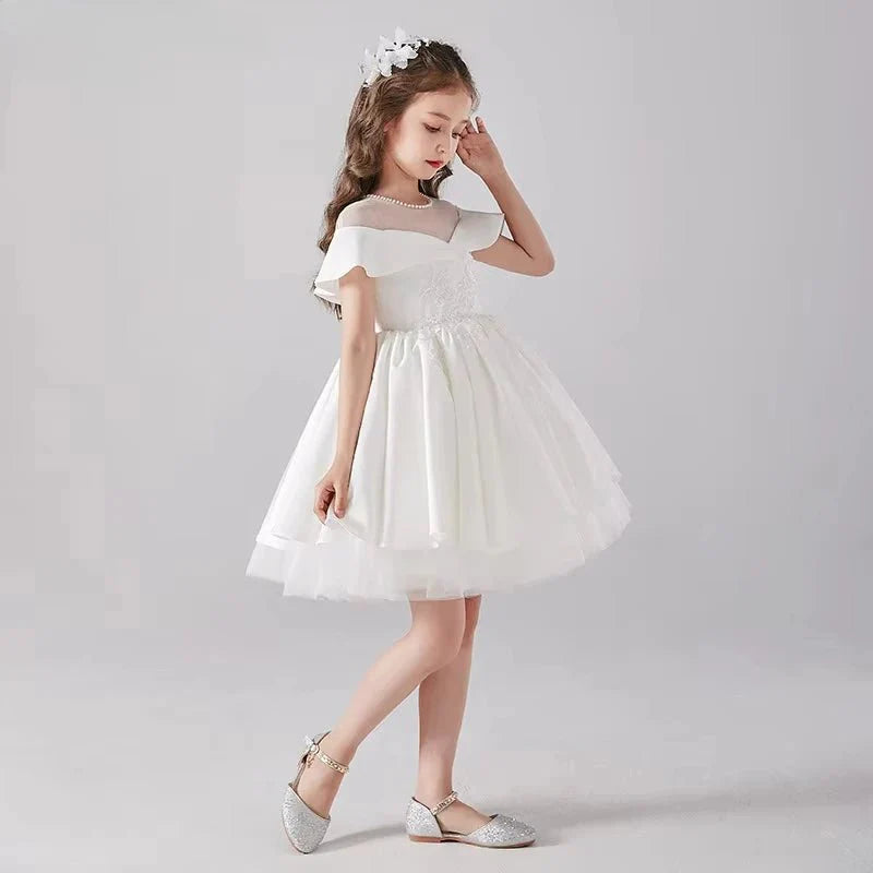 Babelio flower girl in elegant white dress with floral headpiece and sparkling shoes